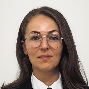 Express Transfer chauffeur with glasses, in a black suit and tie