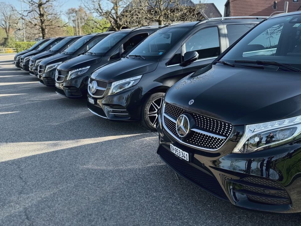 Row of black Mercedes V-Class vans from the Express Transfer fleet