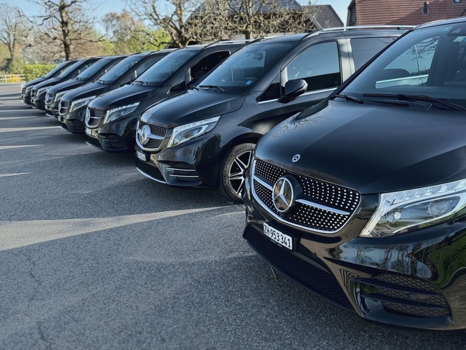 Row of black Mercedes V-Class vans from the Express Transfer fleet