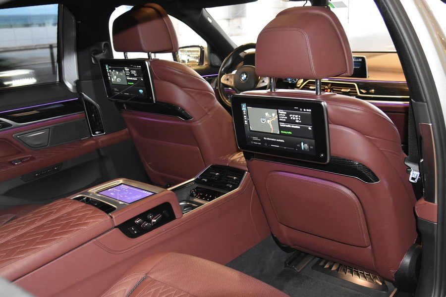 First Class rear cabin in burgundy leather with rear-seat screens