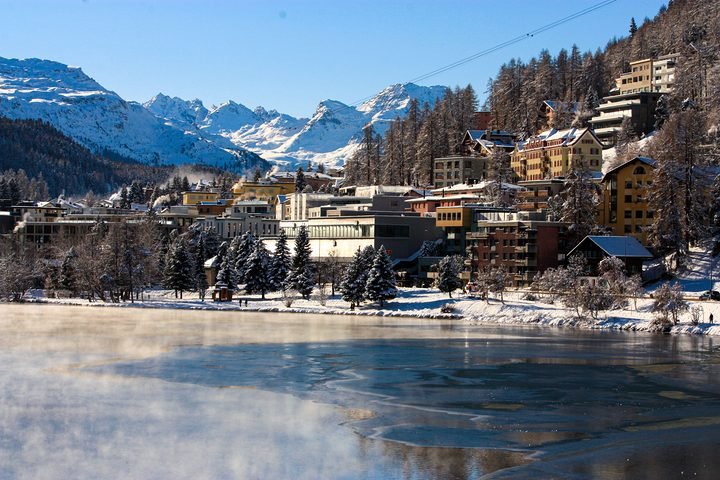 St. Moritz in winter: the town above the lake, snowy mountains behind