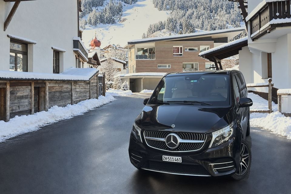 Our black Mercedes V-Class on a snowy village street in St. Anton am Arlberg