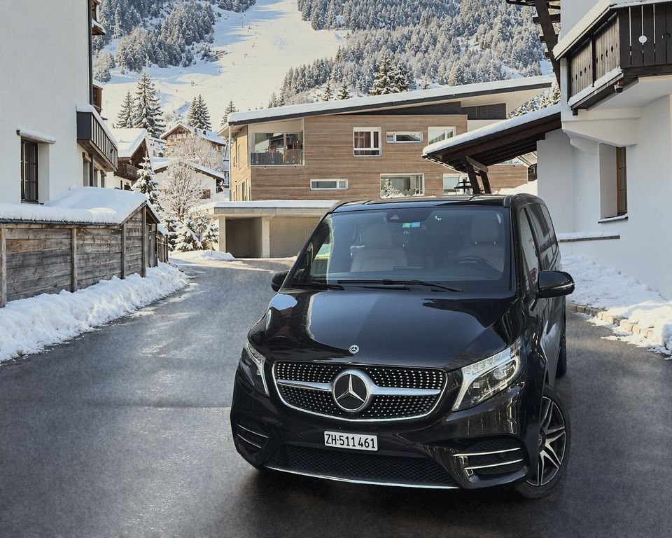 Our black Mercedes V-Class on a cleared street in a snowy mountain village