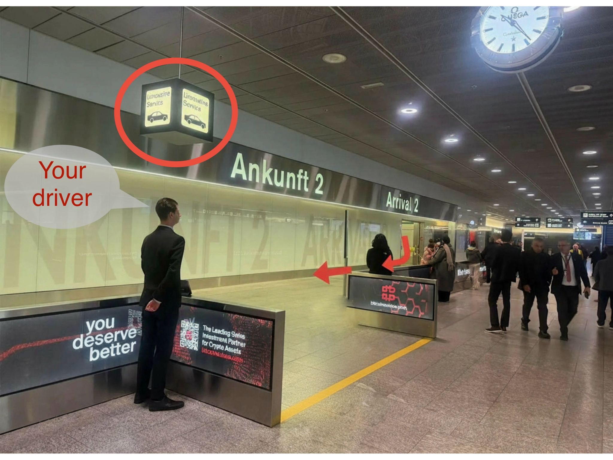 Express Transfer chauffeur meeting point in Zurich Airport arrivals hall — driver with name sign waiting for passenger