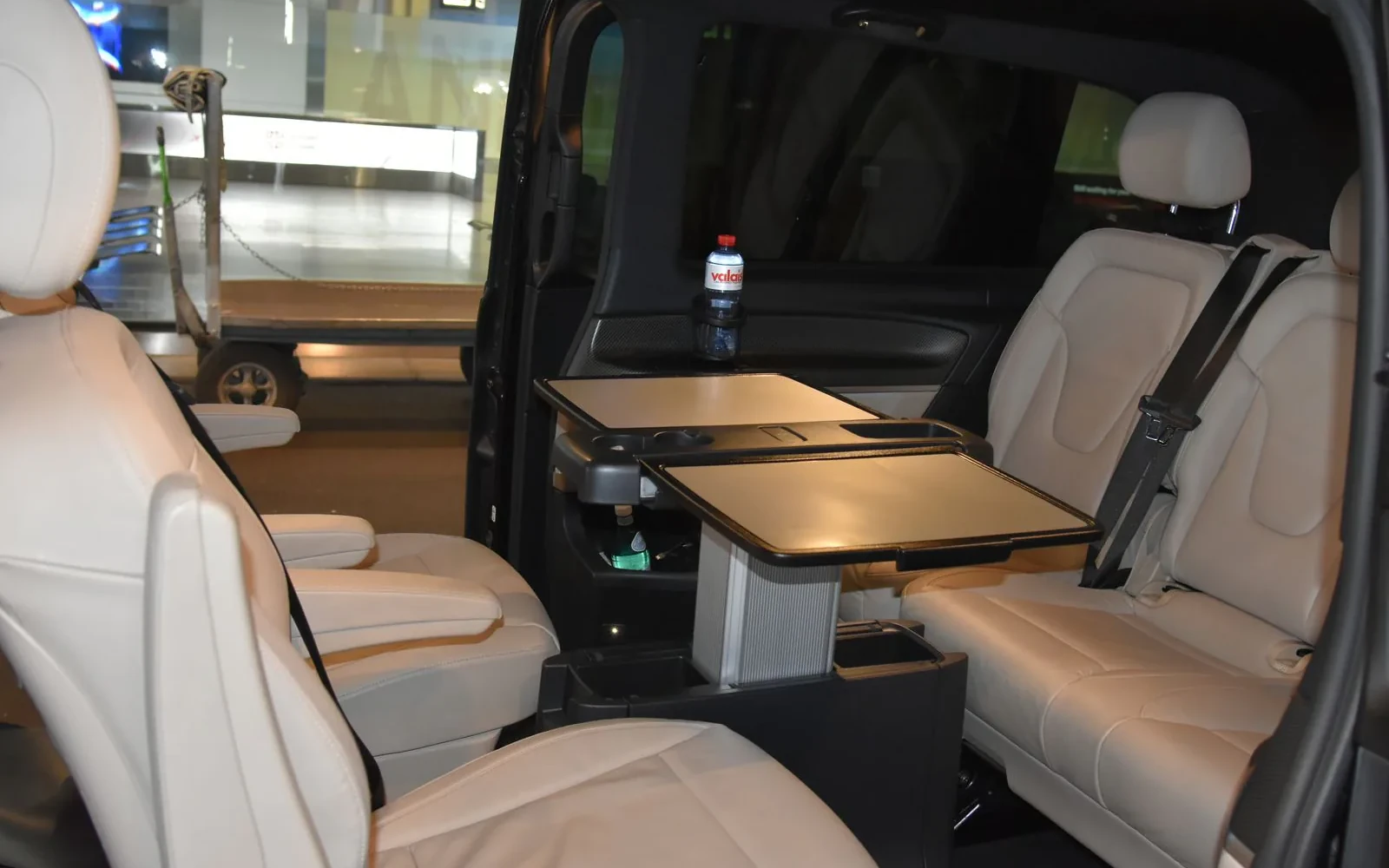 Mercedes V-Class passenger cabin with facing seats and tables.